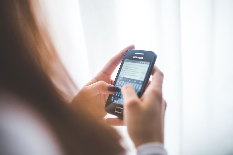 Close-up of a person typing a reply on a smartphone