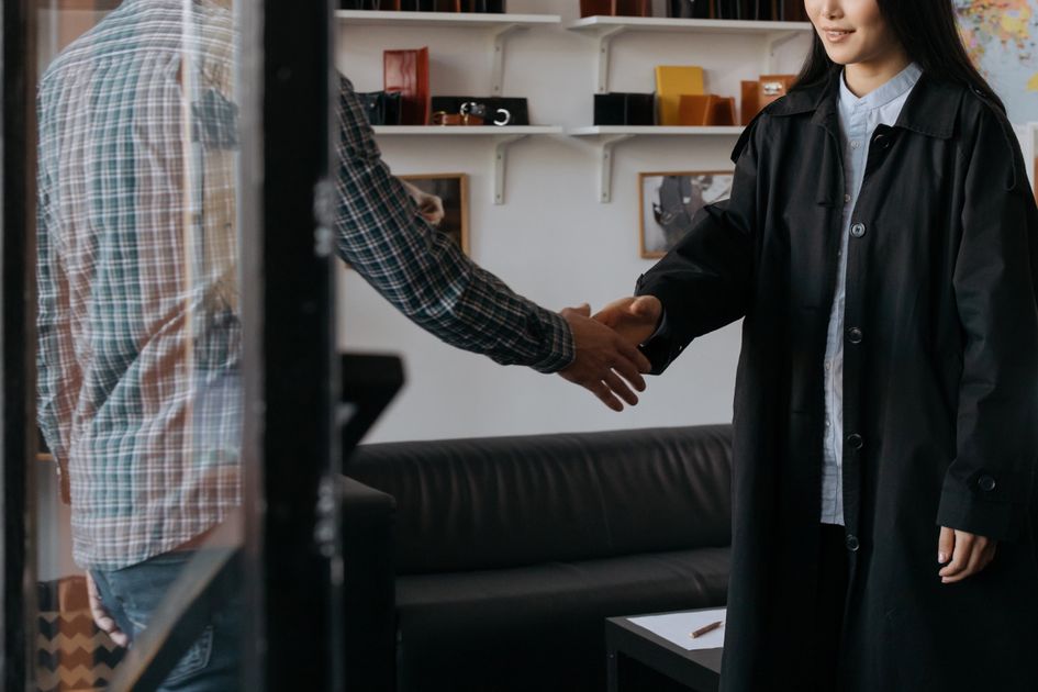 Two professionals shaking hands in an office setting