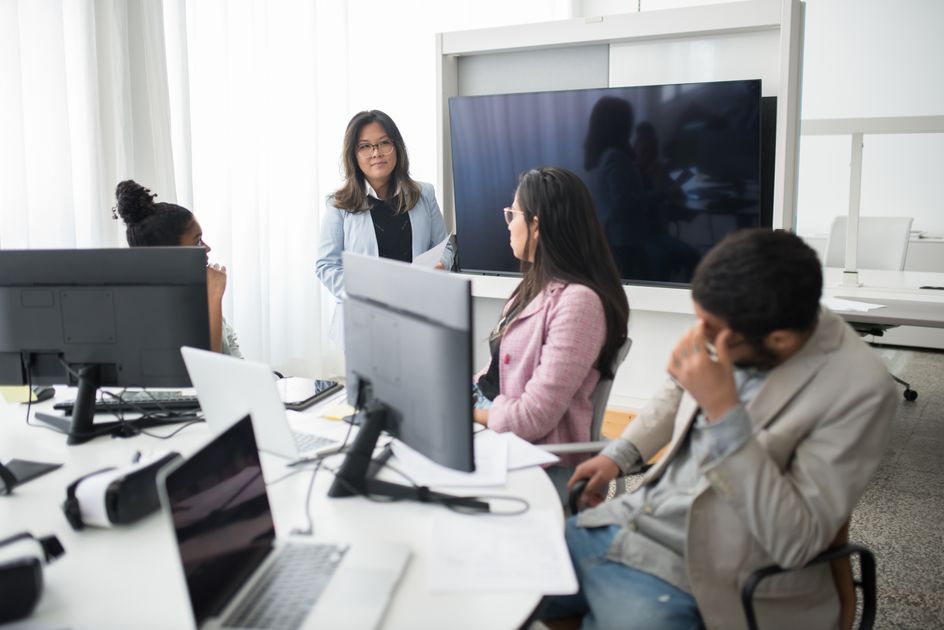 A team meeting around computers in a modern office