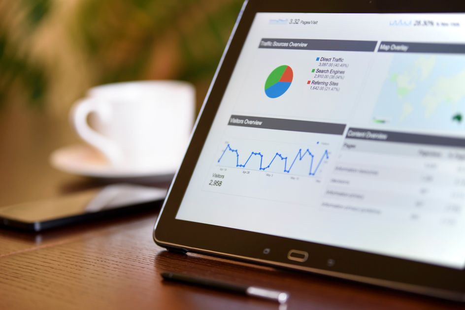 A tablet showing analytics on a wooden desk