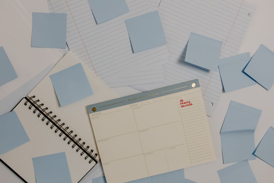 A desk with a planner and sticky notes for organizing content