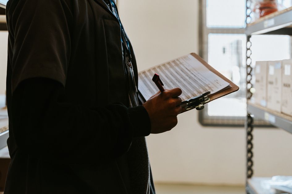 A worker managing a checklist on a clipboard