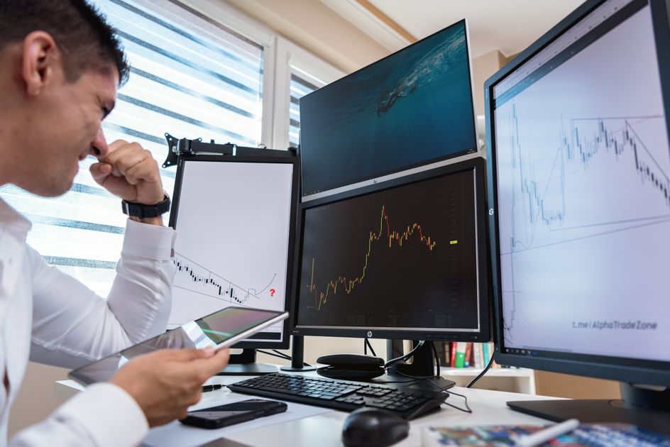 A team meeting with multiple screens showing client dashboards