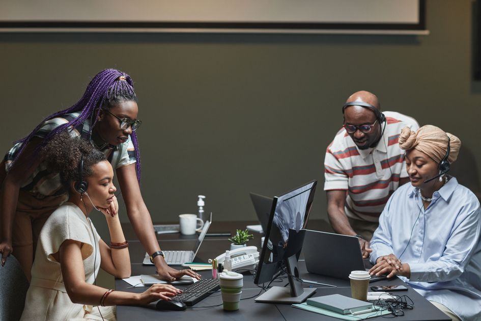 A diverse team collaborating with headsets in an office