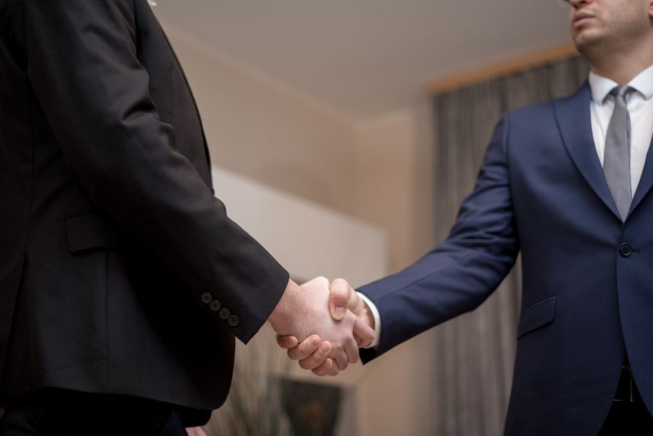 Two businessmen shaking hands after a successful deal