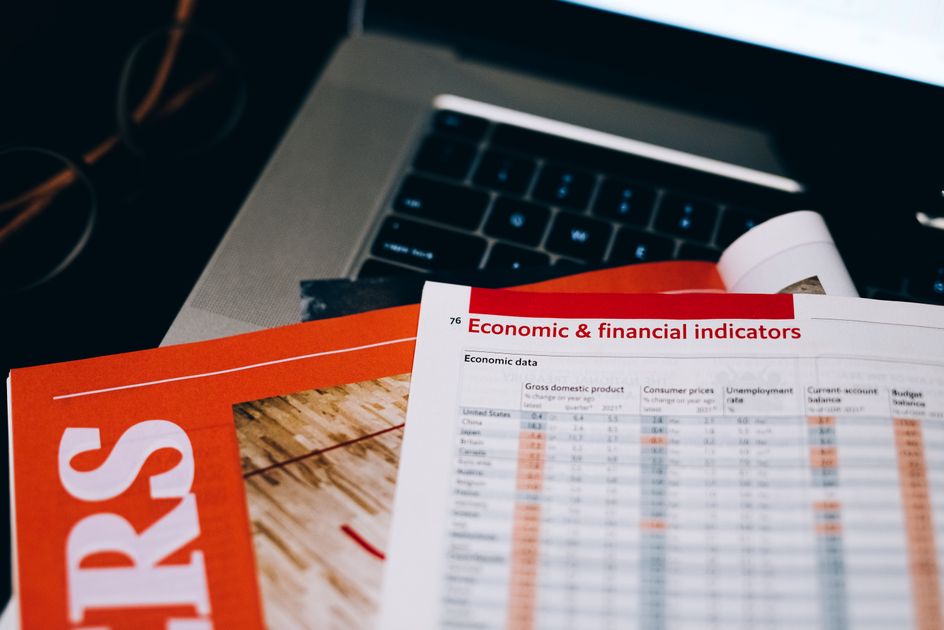 Financial documents on a laptop keyboard