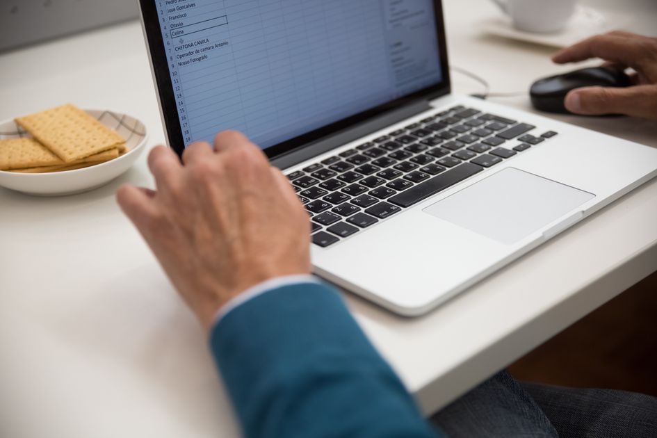 A person working on a laptop at a desk