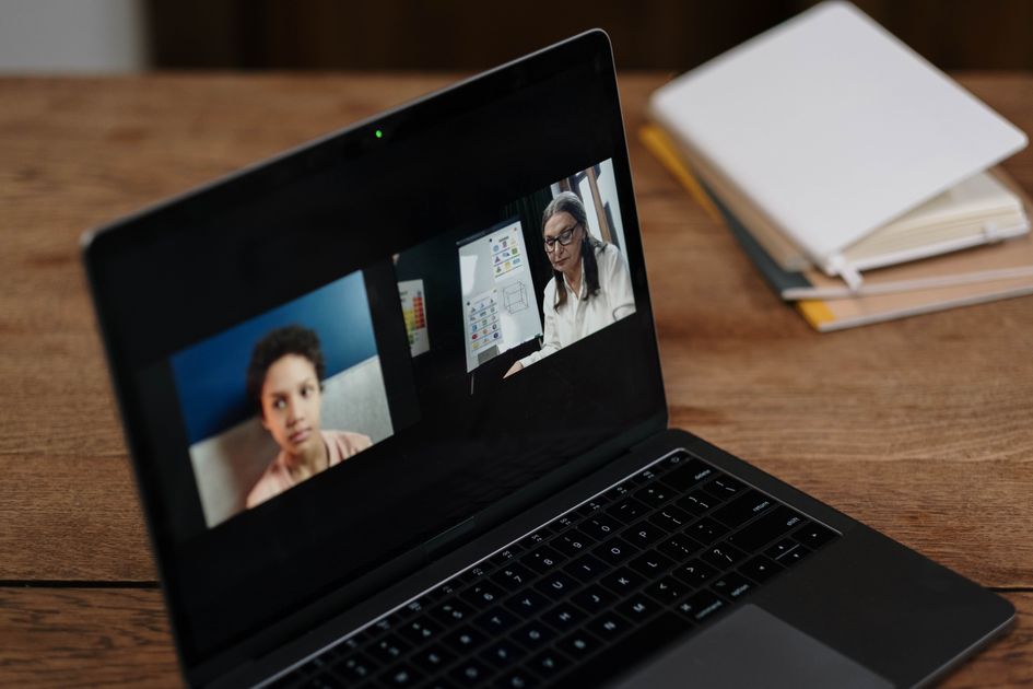 A person taking an online class from a laptop