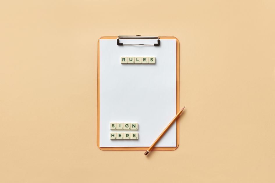A clipboard with rules spelled out in letter tiles