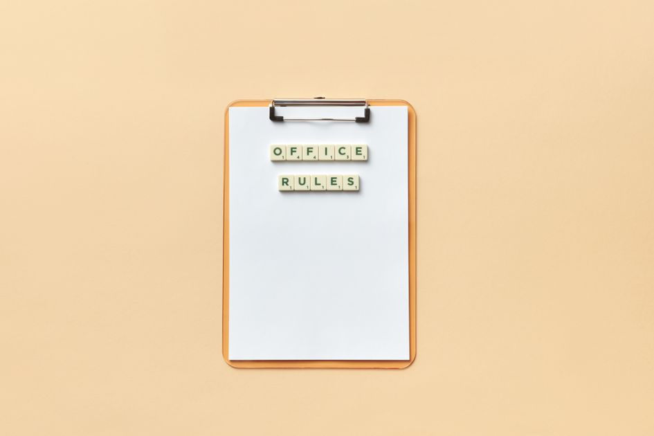 Office rules spelled out with letter tiles on a clipboard