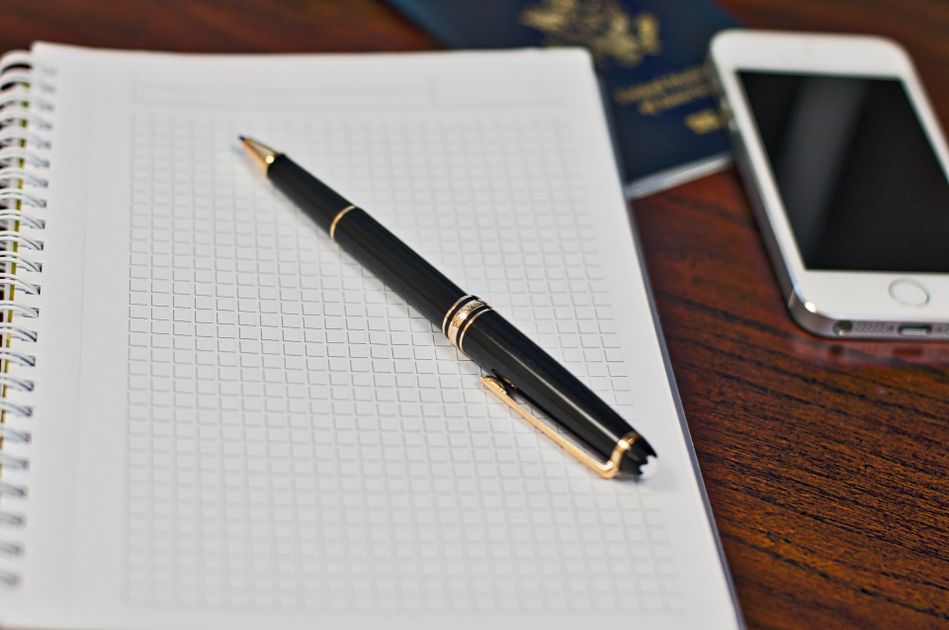 A pen resting on a notebook, ready to write down rules