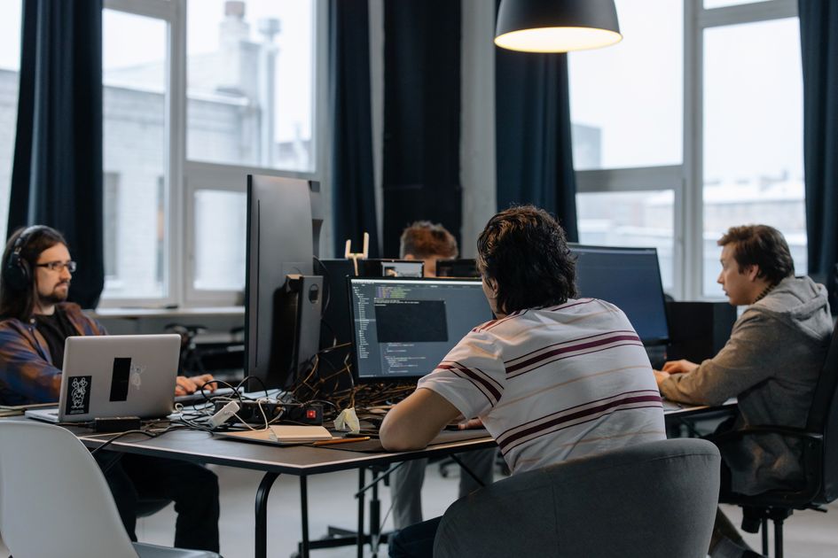 A team working together at computers in a modern office