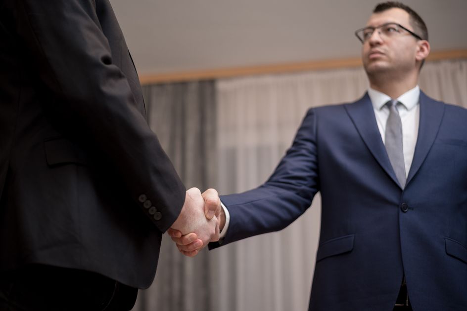 Two professionals shaking hands on a clear agreement