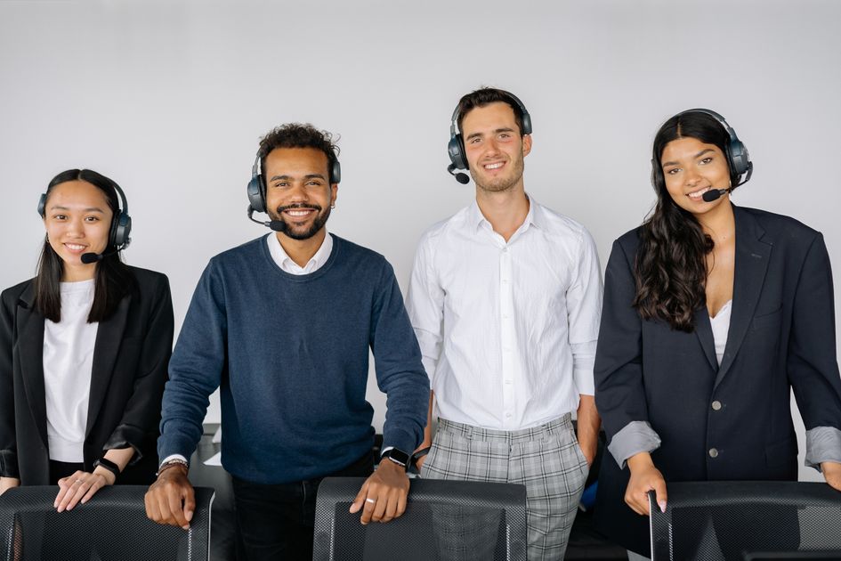 A group of representatives wearing headsets in a busy office