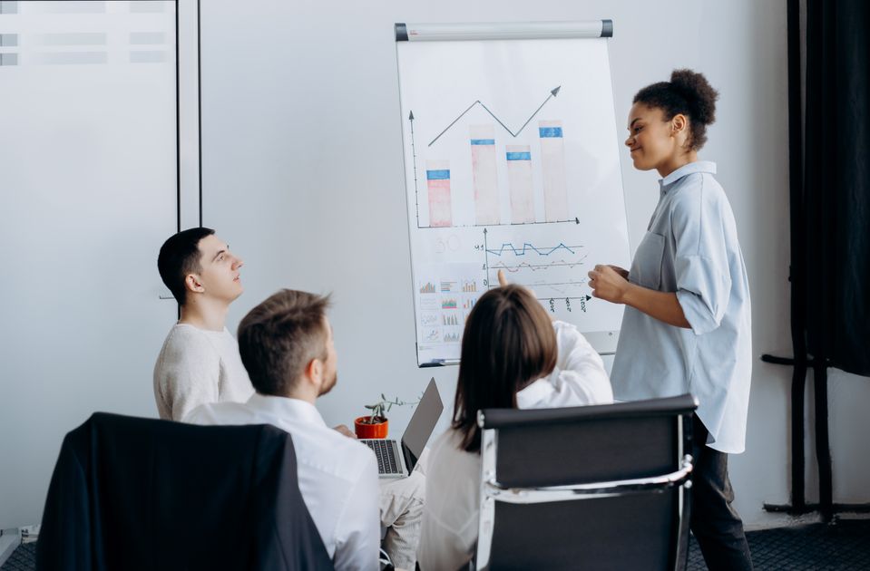 A multicultural team brainstorming business strategy with charts
