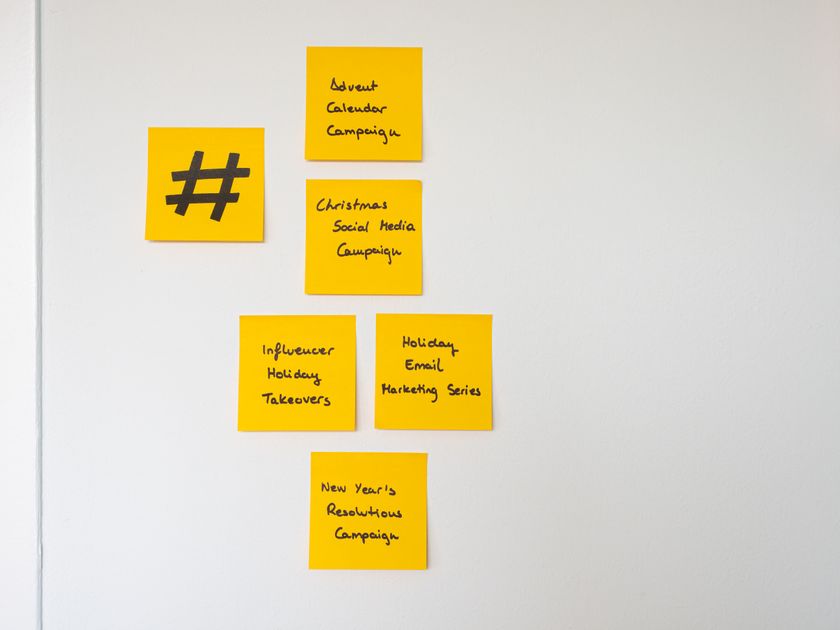 Organized yellow sticky notes on a wall for marketing strategy
