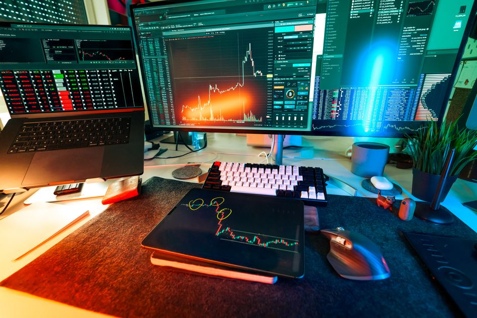 A vibrant trading-style desk setup with multiple screens displaying organized data