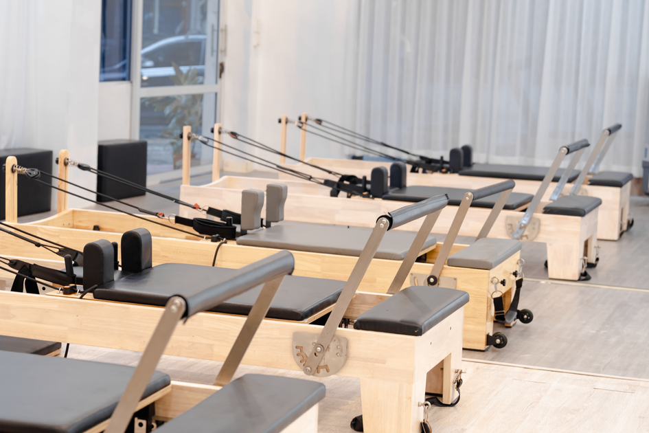 A modern fitness studio with rows of equipment