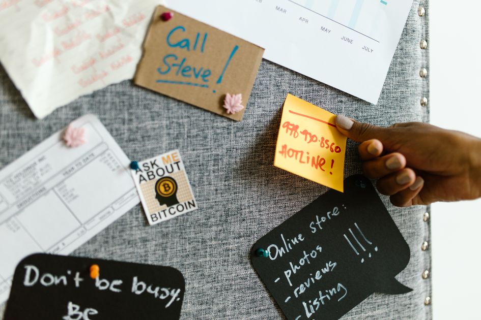 A team discussing project strategies with colorful sticky notes on a board