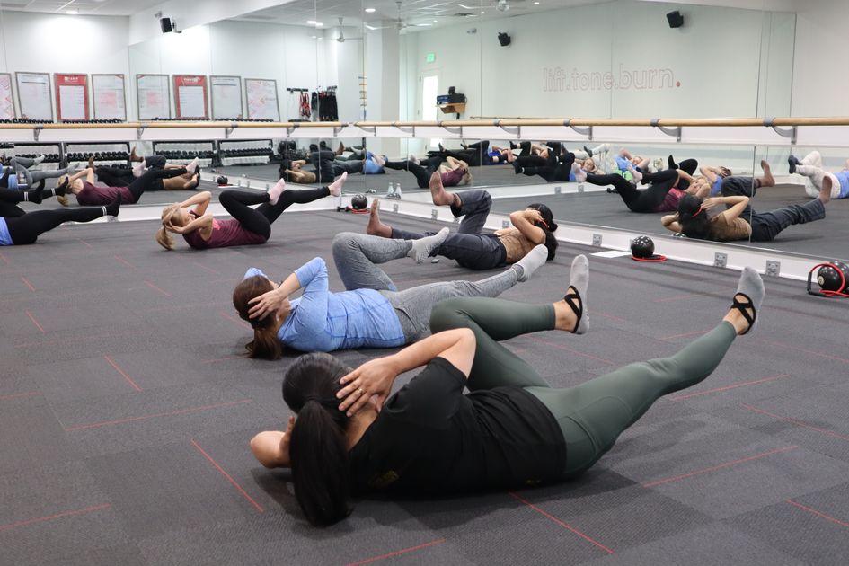 A group fitness class engaged in a core workout
