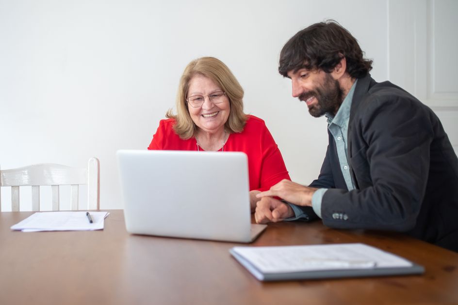 Two colleagues working together on a laptop indoors