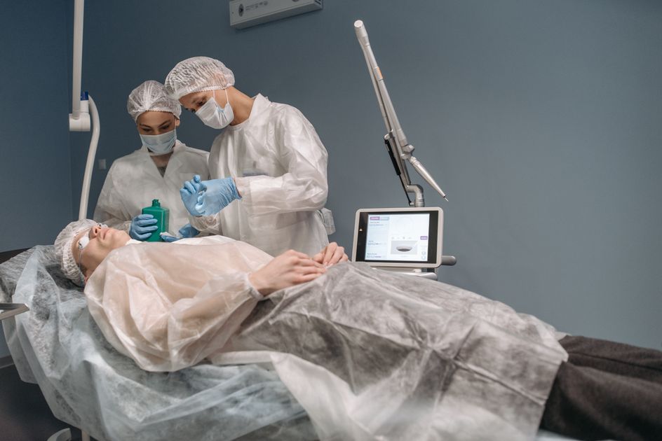 Two clinicians attending to a patient in a treatment room