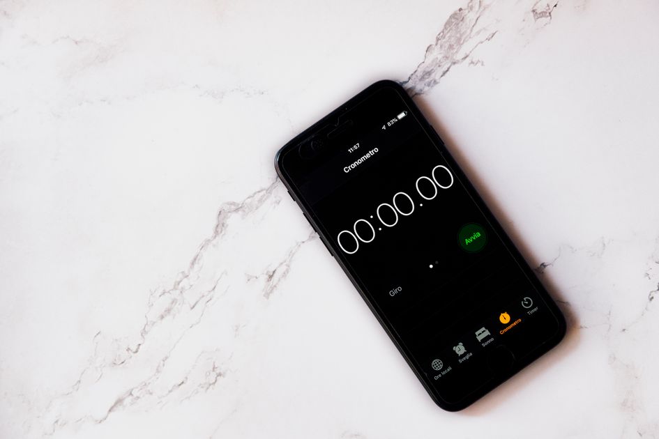A digital timer displaying three minutes on a wooden table