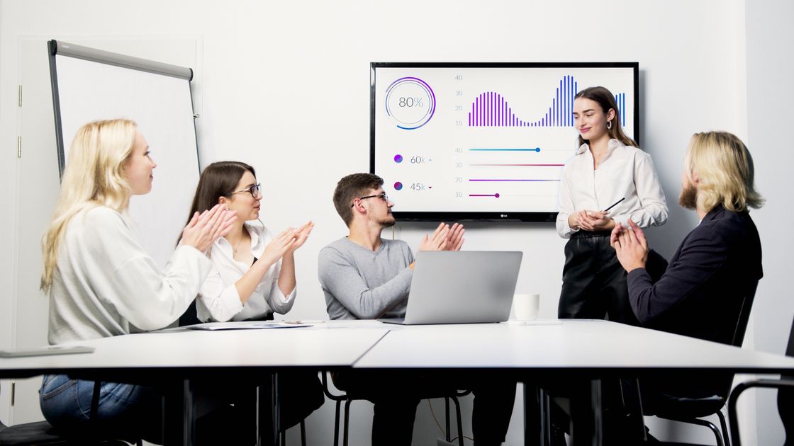 A professional presentation with a team discussing data charts