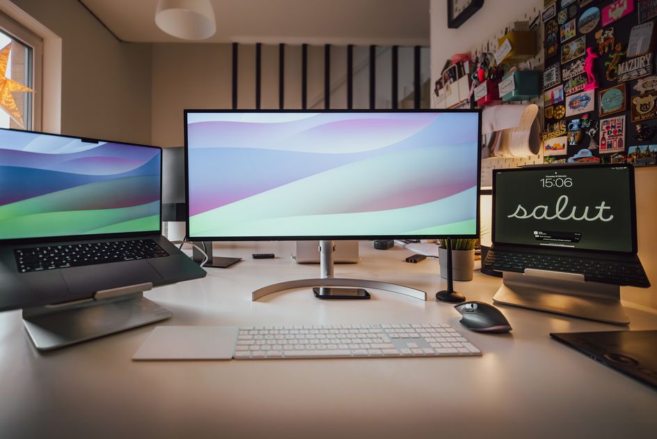 A well-organized home office setup featuring multiple screens