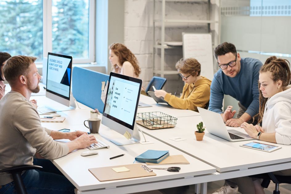 A team collaborating at computers in an office
