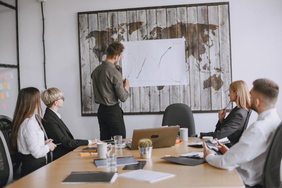 Business professionals discussing strategies with a growth chart