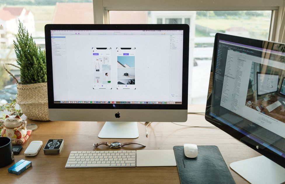 A well-organized modern office setup with multiple monitors