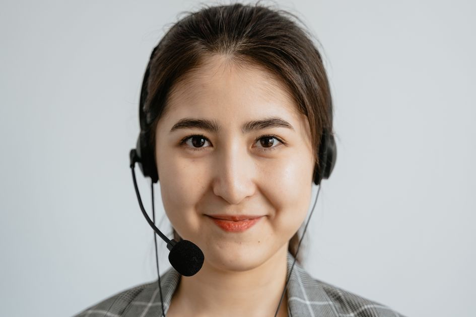 A smiling customer service representative wearing a headset