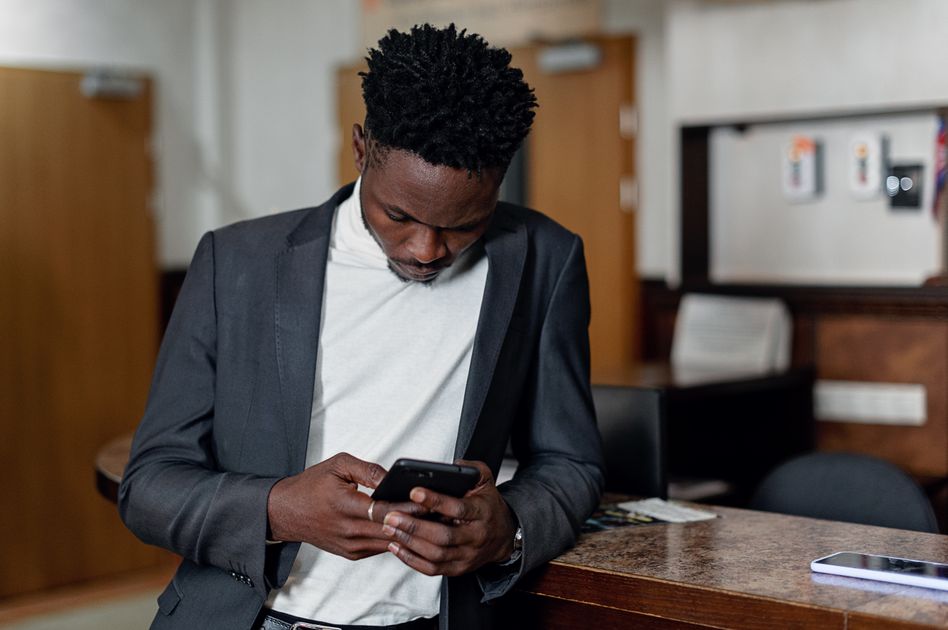 A professional man focused on his mobile phone