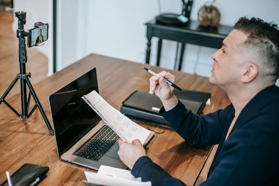 A person engaged in an online session using a laptop