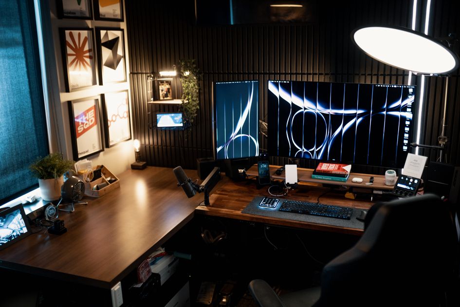 A cozy modern home office setup featuring dual monitors
