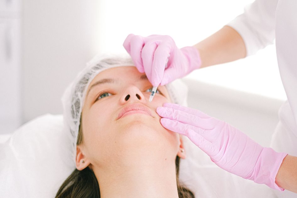 A woman receiving a cosmetic treatment in a clinic