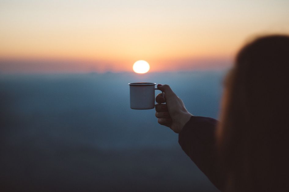 A relaxed morning moment with coffee at sunrise