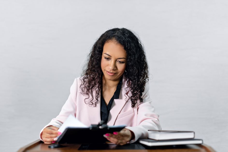 A confident woman reviewing documents at a desk