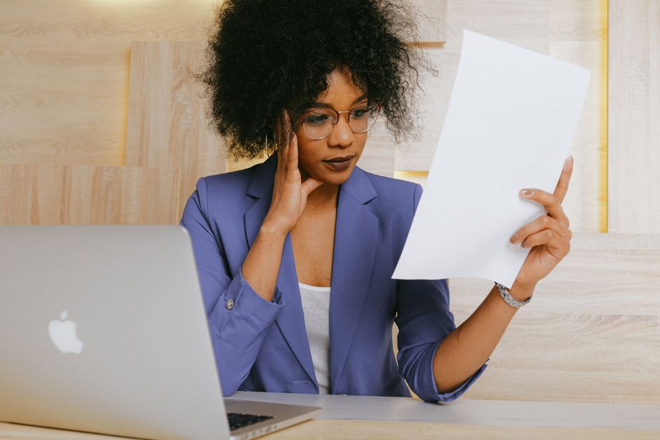 A businesswoman reviewing a document at the office