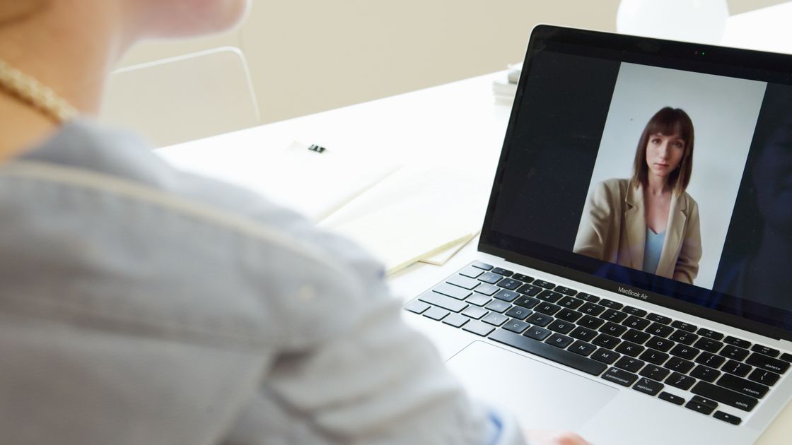 A person on a video call using a laptop