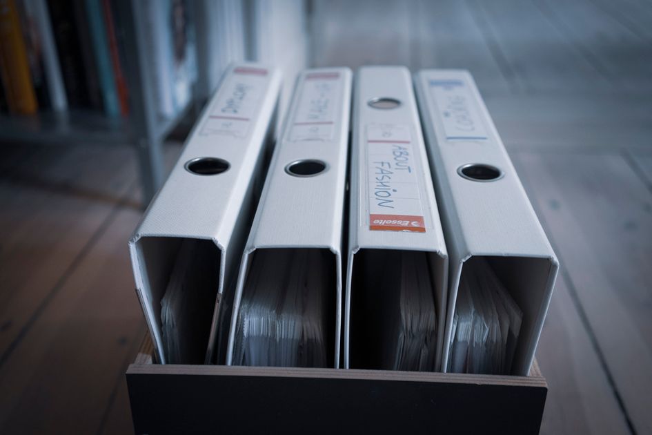Folders with plastic sleeves and titles arranged neatly