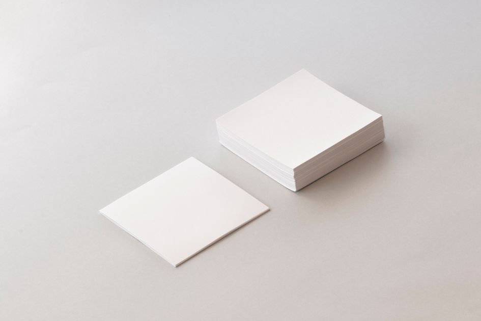 A stack of blank paper with a single sheet on top