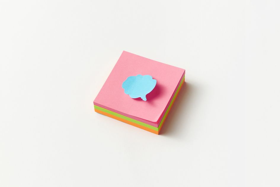 A stack of colorful sticky notes with one note on top