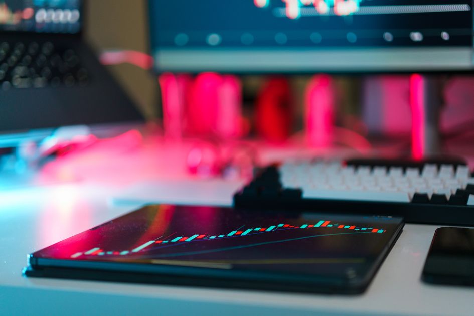 A trading setup with charts on tablet and computer screens