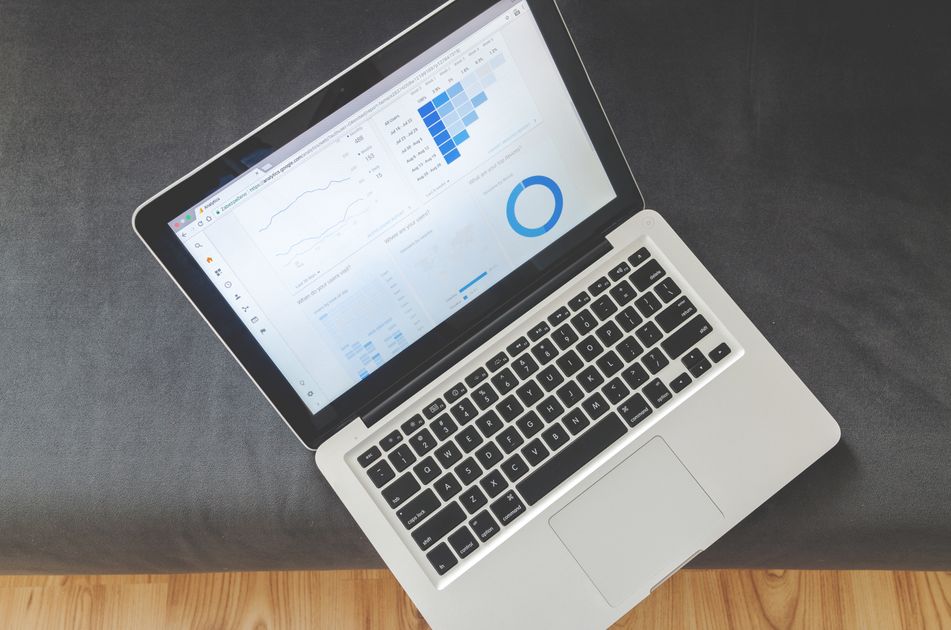 A laptop showing data visualizations and charts