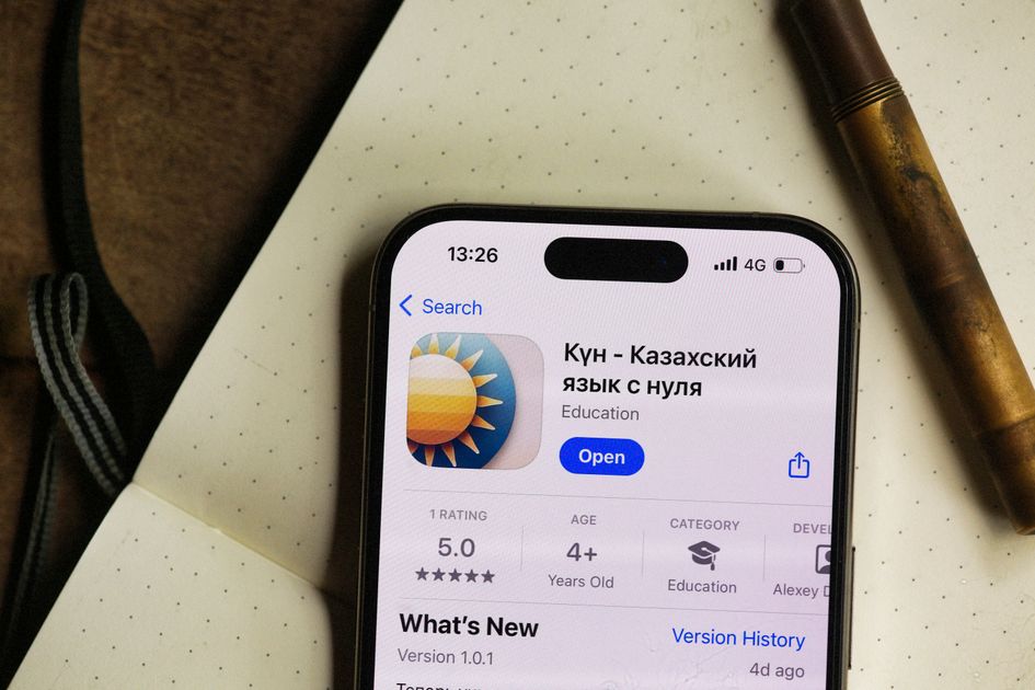 A smartphone displaying a rating app in a cozy setting