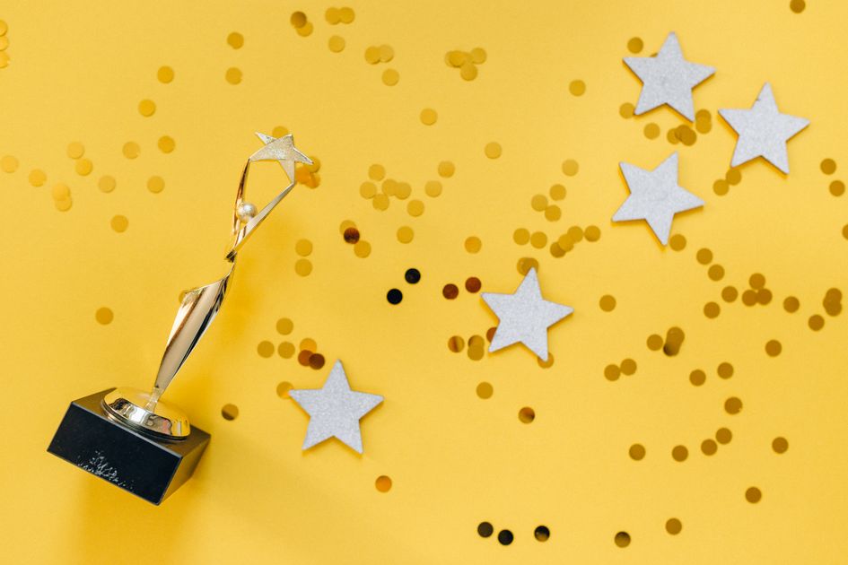 A golden trophy and stars on a vibrant background