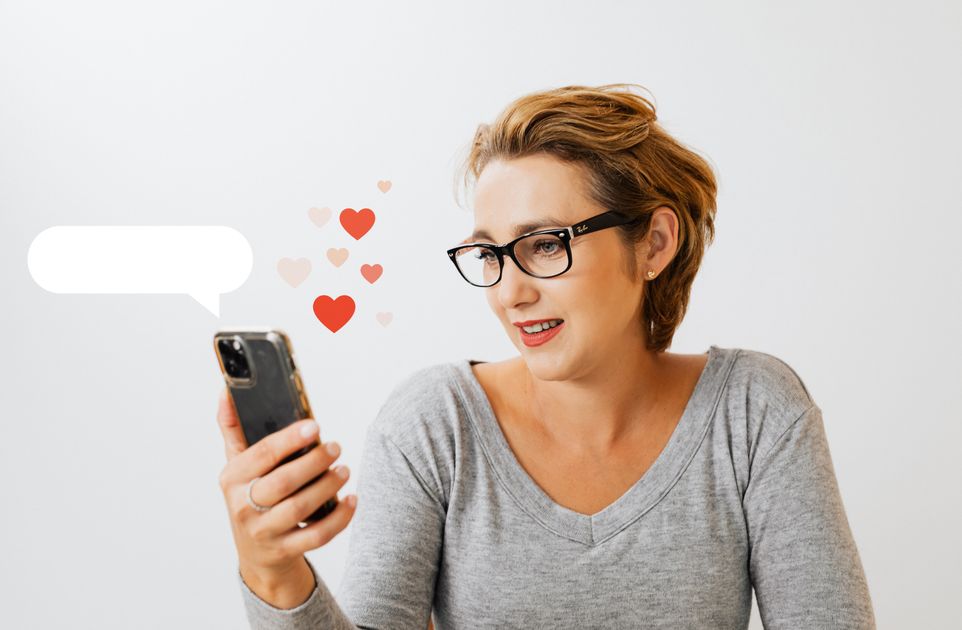 A woman wearing glasses using a smartphone