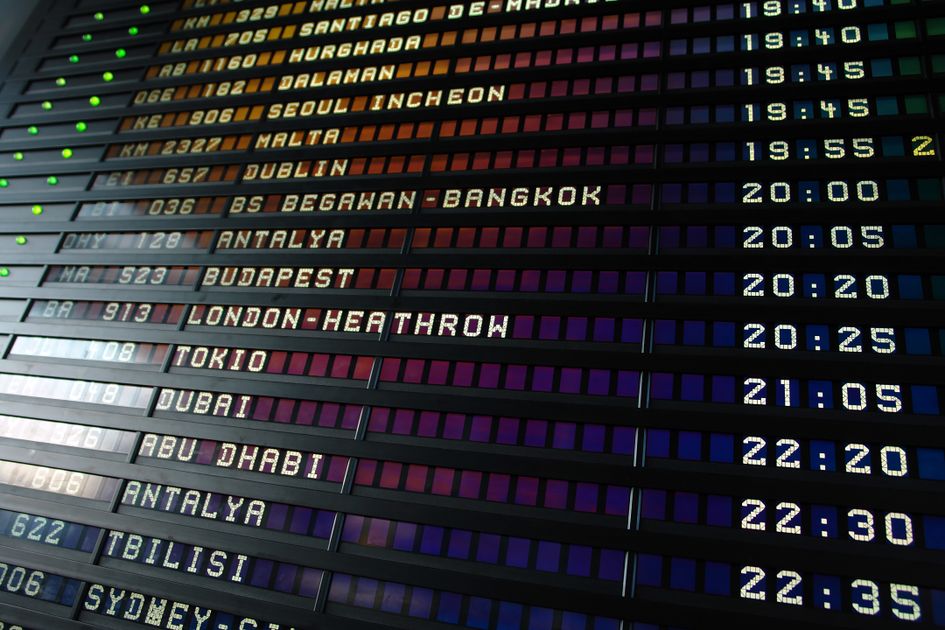 A retro flip-style departure board showing schedules